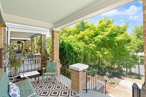 A covered outdoor area with a patio, seating, and a view of trees. - Hill East, Barney Circle 2-BR, Walk to METRO Stop (Washington)