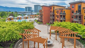 A hotel with multiple floors, outdoor seating areas, and a pool.