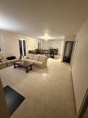 A living room with a sofa, a coffee table, and a dining area with chairs and a table. - Provencal house with private pool (Salernes)