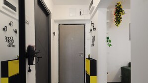 A hallway with a door, black and yellow storage units, and motivational wall art. - Nova City View+ Near Hospital+Full Kitchen+A/C+Free Public Parking (Bucharest)