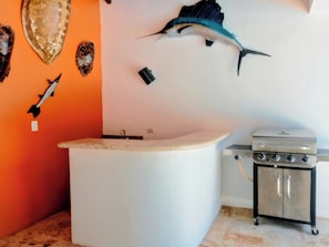 A bathroom with a bathtub, a sink, and a stove.