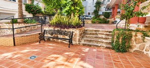 A courtyard with a stone bench, steps, and potted plants. - "Fuengirola" "San Francisco Beach" by Accommodation (Fuengirola)