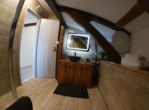 A small, wooden-framed room with a wooden vanity, a mirror, and a door. - Guest House Dea (Mrkopalj)