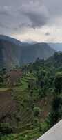 Terraced fields, a few buildings, and a mountain range.