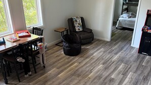 A room with a dining table, chairs, a massage chair, a bed, and a game console. - Deer Run on Eddy Bay
4 bd , 3 bath luxury lake living! (Eddyville)