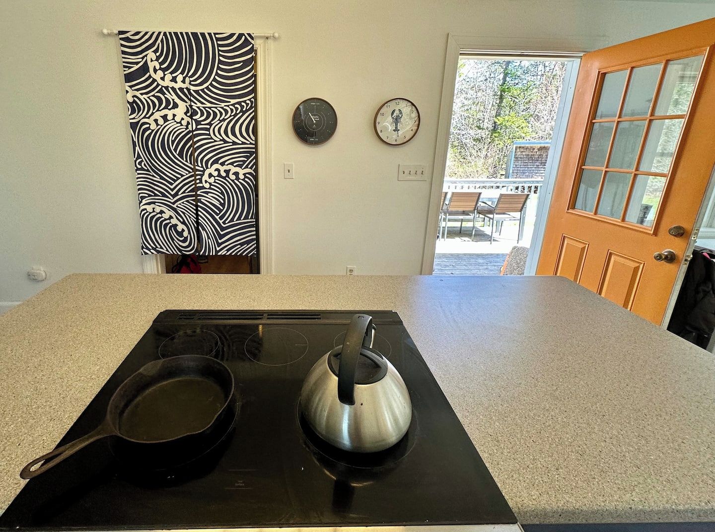 Japanese Noren curtain leads to kitchen storage and appliances- laundry and fridge.