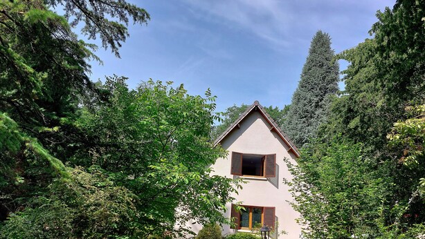 A house with a gabled roof, a visible window, and a pathway leading to it. - The 3 Pignons gourmet refuge (Noisy-sur-École)