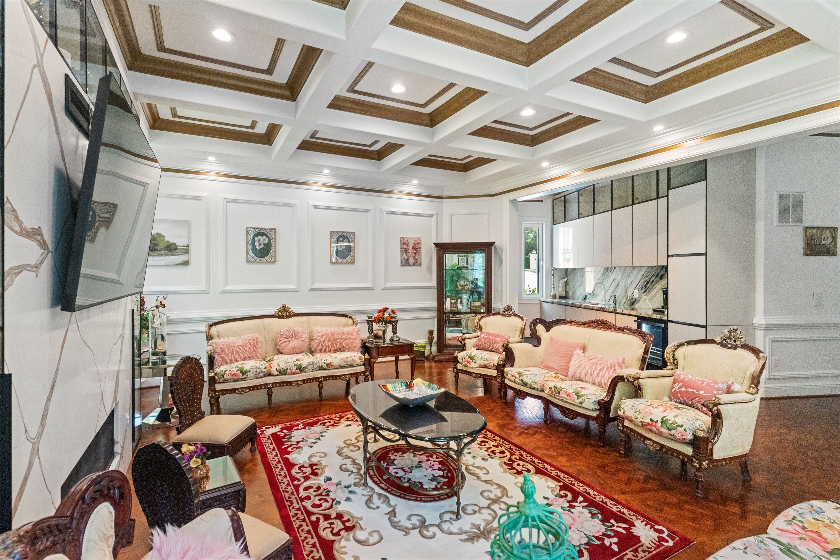 A spacious living room with ornate ceiling, plush sofas, a coffee table, and a television.. McLean Estate | 7BD | BBQ-Parking-Luxury Theater