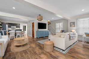 A modern living room with a sofa, coffee table, and TV.