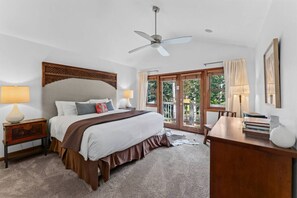 A bedroom with a bed, a desk, a chair, a ceiling fan, and a view through a glass door. - EagleVail Oasis on the 6th Fairway w/Hot Tub (Avon)