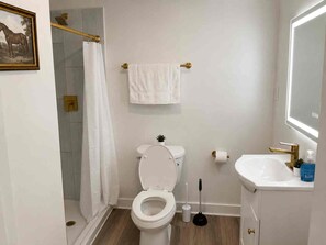 Ein Badezimmer mit Toilette, Waschbecken und Dusche.