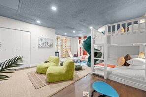 A children's playroom with bunk beds, a slide, and a climbing wall. - Pool, Hot Tub, PickleBall, Firepit, 5 min to IMG (Bradenton)