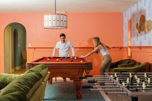 A room with a pool table, a foosball table, and a billiards table. - Pool, Hot Tub, PickleBall, Firepit, 5 min to IMG (Bradenton)