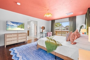 A bedroom with a bed, a dresser, a television, and a view of the outdoors. - Pool, Hot Tub, PickleBall, Firepit, 5 min to IMG (Bradenton)