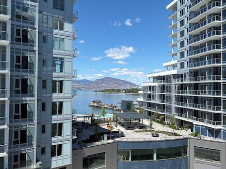 A modern hotel with a view of a lake and mountains.