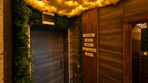 A wooden wall with a cloud-like ceiling, a sign reading 'HOME IS Where the heart IS,' and a door with a small window. - Cozy Chalet with Jacuzzi, Heated pool & Sauna Montebliss (Miljevići)