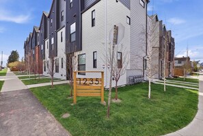 A modern apartment building with a sign indicating unit number 1235. - Beautiful 3BR Getaway in Trendy NW Calgary (Calgary)