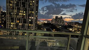 A high-rise building with a view of a cityscape at dusk. - FIFA unobstructive view CN TOWER lakeshore 1+1(den) 2b1b condo with parking (Toronto)