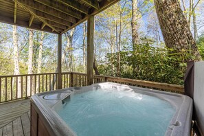 A hot tub on a wooden deck with a view of a forest. - Altitude Adjustment - Seven Devils Cabin With Hot Tub, Pet Friendly, Fireplace (Banner Elk)