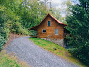 A wooden cabin with a stone foundation, a porch, and a gravel driveway. - Hidden Serenity Hot Tub, Fire Pit, Minutes From Boone (Fleetwood)