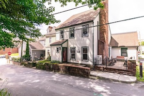 A two-story house with a front porch, a brick chimney, and a mailbox. - The Wander Inn (Blowing Rock)