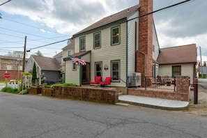 A two-story house with a porch, a stop sign, and a brick chimney. - The Wander Inn (Blowing Rock)