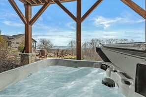 A hot tub under a wooden pergola with a view of a house and landscape. - Eagle Rare Retreat at Eagles Nest (Banner Elk)