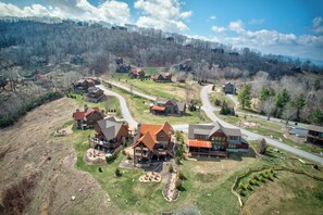 A residential area with houses, roads, and a hilly landscape. - Eagle Rare Retreat at Eagles Nest (Banner Elk)