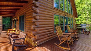 A log cabin with a deck, rocking chairs, and a grill area. - Atop Banner Elk (Banner Elk)