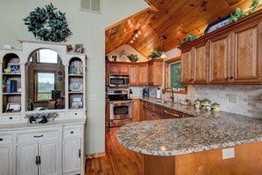 A kitchen with wooden cabinets, granite countertops, and stainless steel appliances. - 1 Beautiful View (Blowing Rock)
