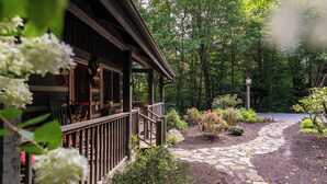 A wooden cabin with a stone pathway leading to a garden area. - Scarborough Fair (Banner Elk)