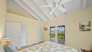 A bedroom with a bed, a ceiling fan, a balcony, and a door. - Banner Elk Valley Overlook (Banner Elk)