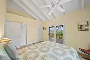 A bedroom with a bed, a ceiling fan, a balcony, and a door. - Banner Elk Valley Overlook (Banner Elk)