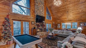 A cozy cabin interior with a pool table, fireplace, and comfortable seating area. - Blueberry Hills 3BR With hot Tub, pet Friendly, Outdoor Fireplace (Boone)