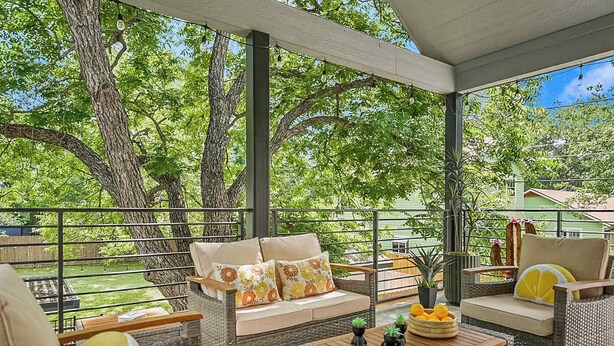 A covered outdoor seating area with wicker furniture, a table, and potted plants. - SoCo 2BR South Austin Modern Gem & Very Walkable! (Austin)