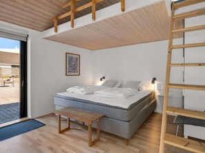 A bedroom with a bed, a bench, a ladder, and a framed picture on the wall. - "Isalie" - 300m from the sea by Interhome (Ebeltoft)