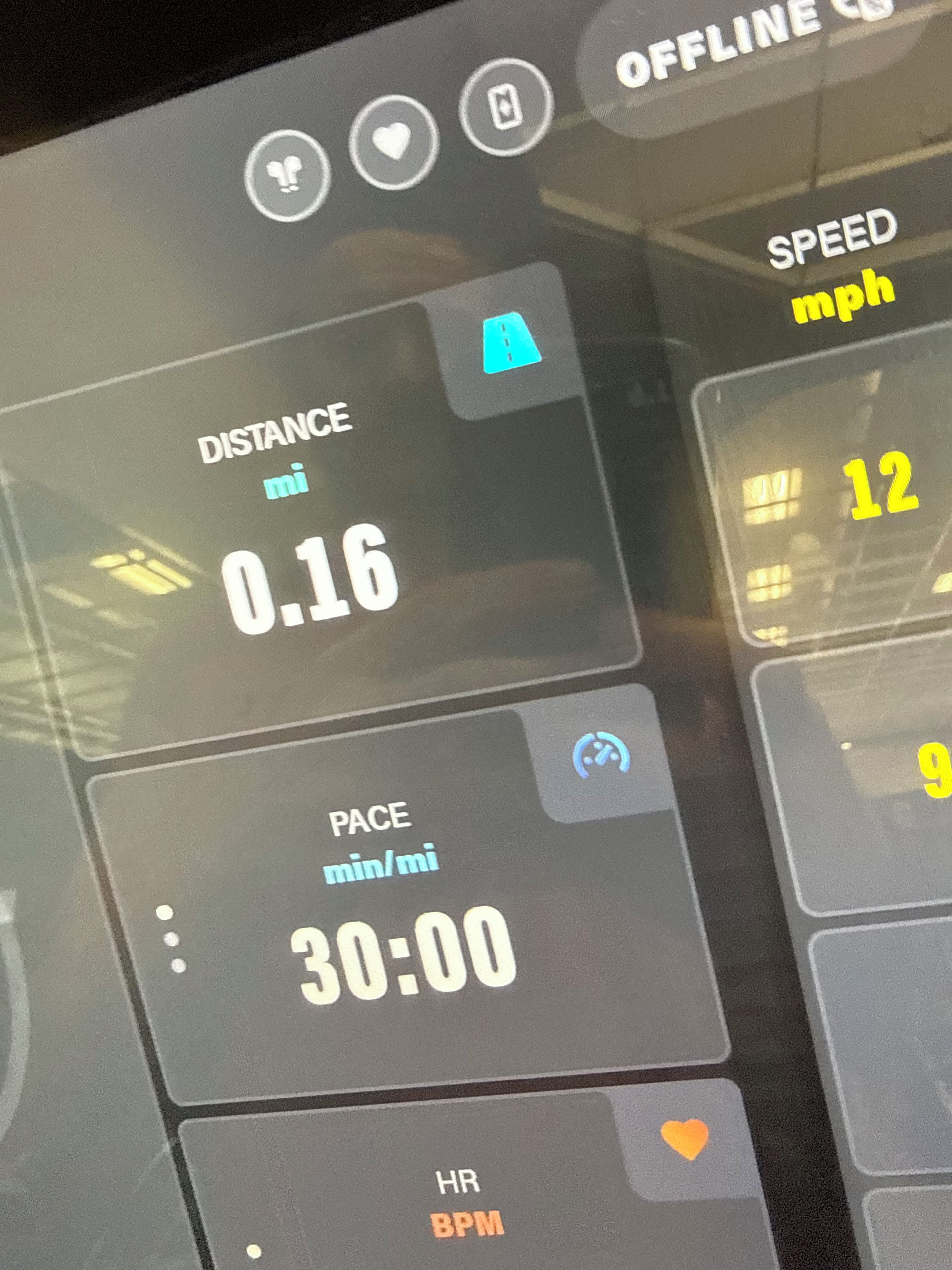 A digital display with distance, pace, speed, and heart rate metrics.