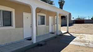 A building with a covered walkway, numbered doors, and a tiled entrance. - Cozy Rooms Rocky Point - Walk to Playa Hermosa (Puerto Penasco)