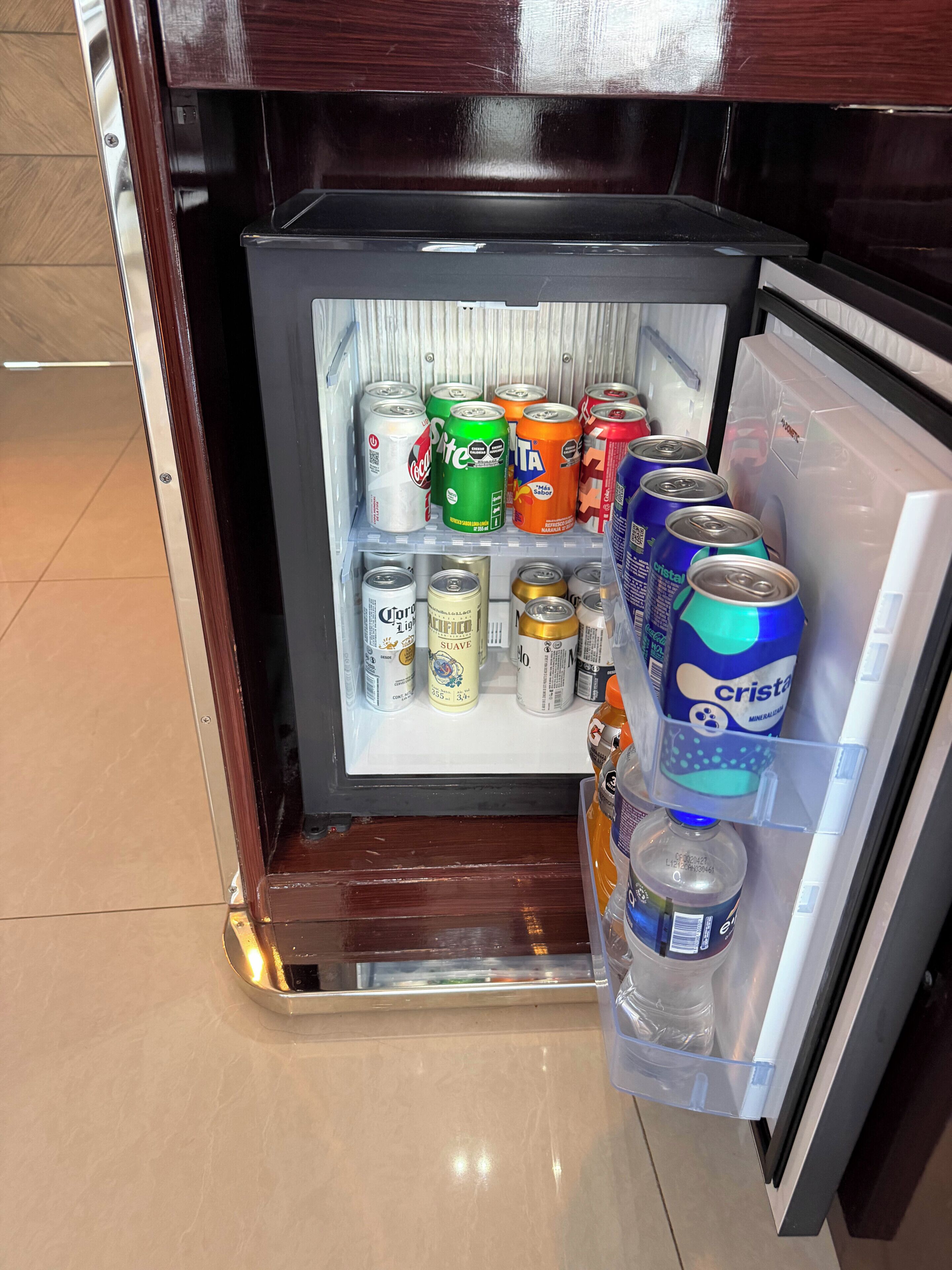 A mini-fridge stocked with various beverages and a water dispenser.