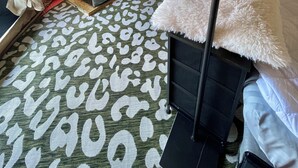 A tent with a bed, a heater, and a small table. - Air conditioned Glamping Tent overlooking a beautiful orchard (Merritt)