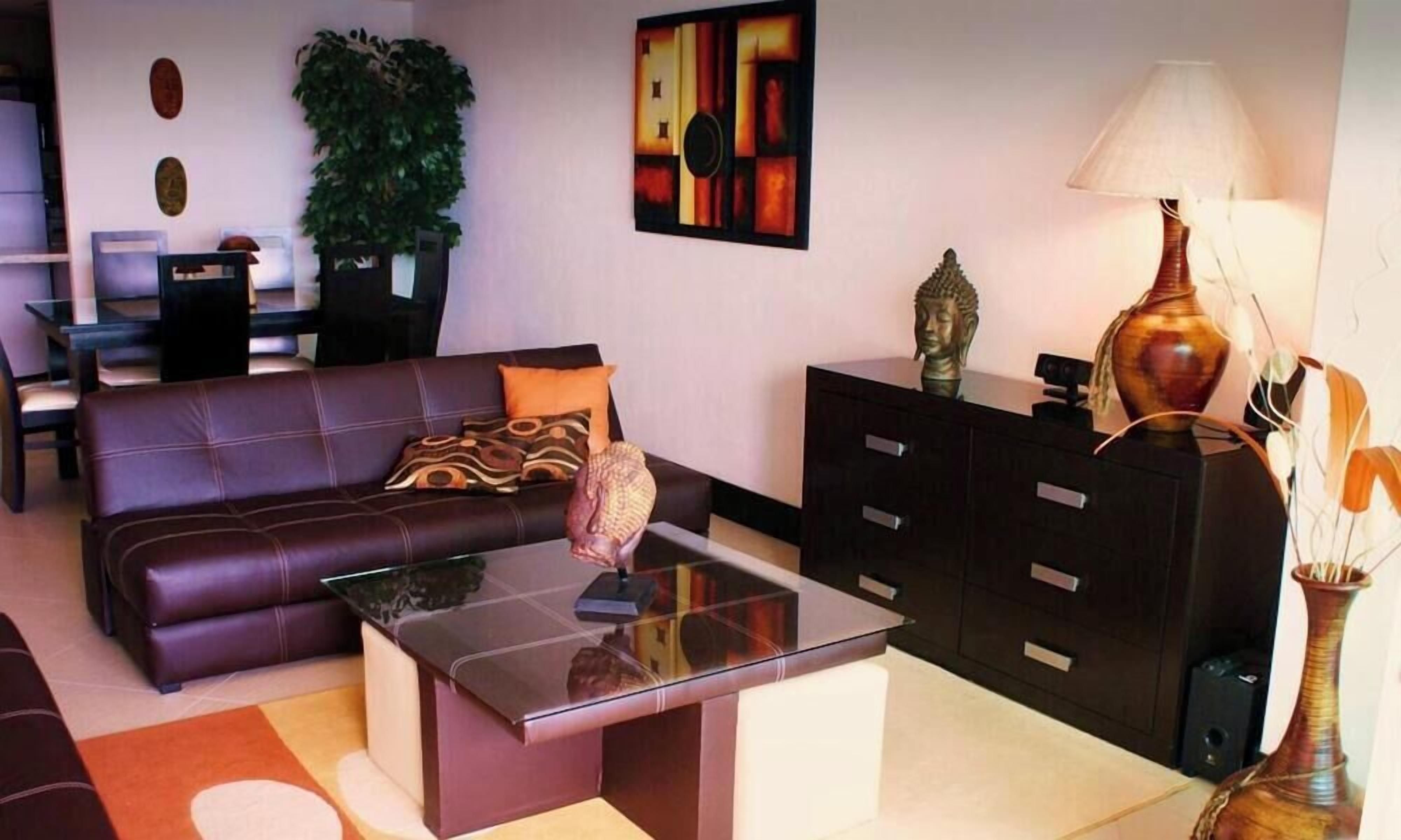 A living room with a sofa, coffee table, and a cabinet.