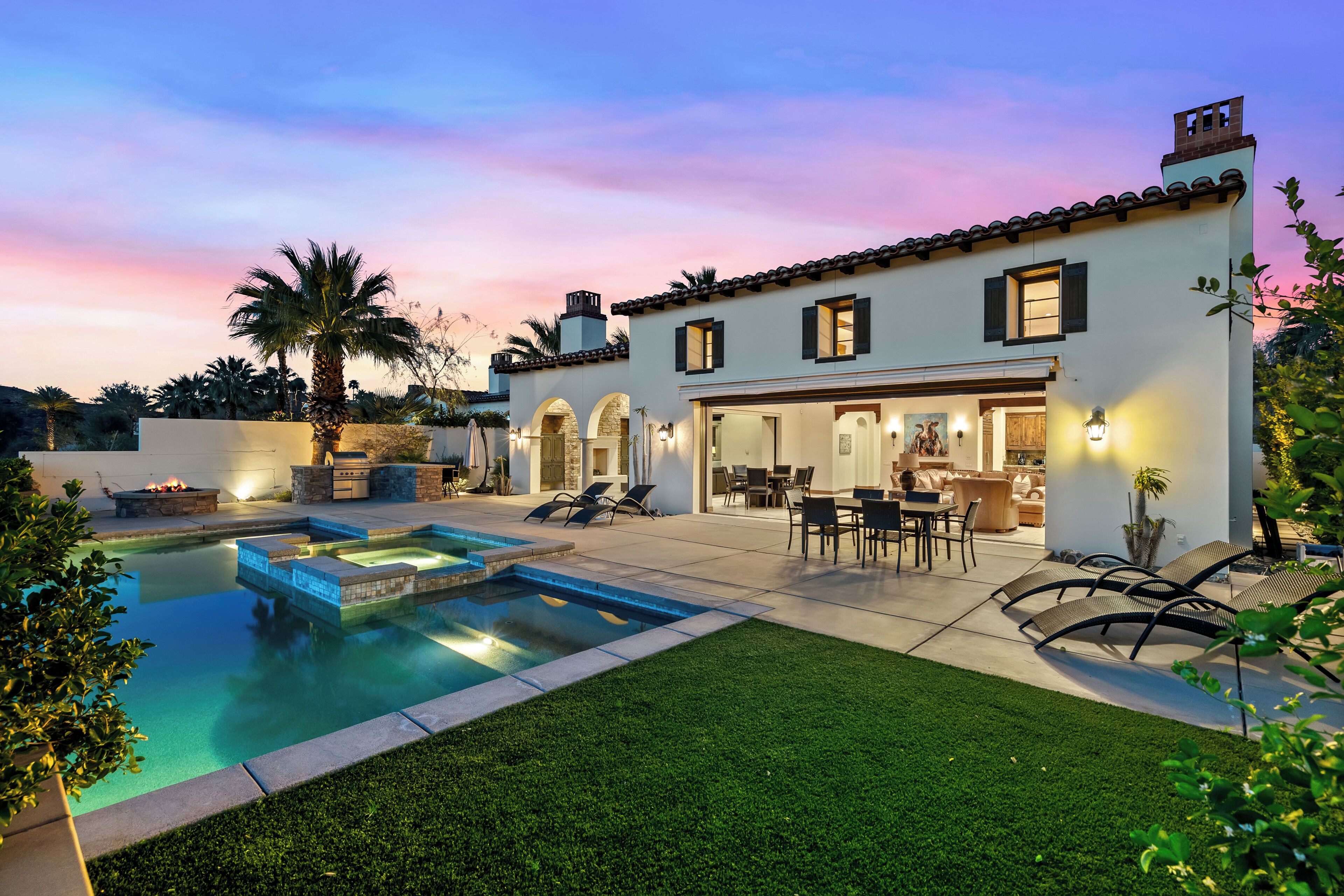 Una casa moderna con piscina, mobiliario exterior y zona de patio.