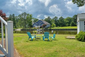 A lakeside property with a dock, a house, and outdoor seating. - The Hoagie House - Family-Friendly Canal Home with Private Dock (Frankford)