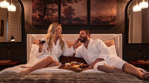A couple in a bedroom with a bed, a tray of snacks, and paintings on the wall. - Fire Pit.   Private Golf Course.   Summer Club Pool (Greeneville)