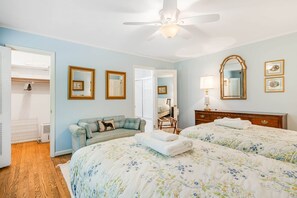 A bedroom with two beds, a ceiling fan, a dresser, and a mirror. - Historic BR Home | Walk to Main St | Pet Friendly (Blowing Rock)