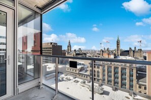 A high-rise building with large windows and a clear view of the cityscape.