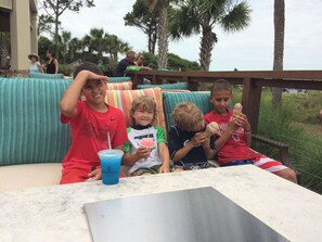 A group of people seated on a bench with a table in front of them. - Available 6/26-7/3/26 only! Sea Pines Villa; 2BR/2BA; Sleeps 6; HHI (Hilton Head Island)