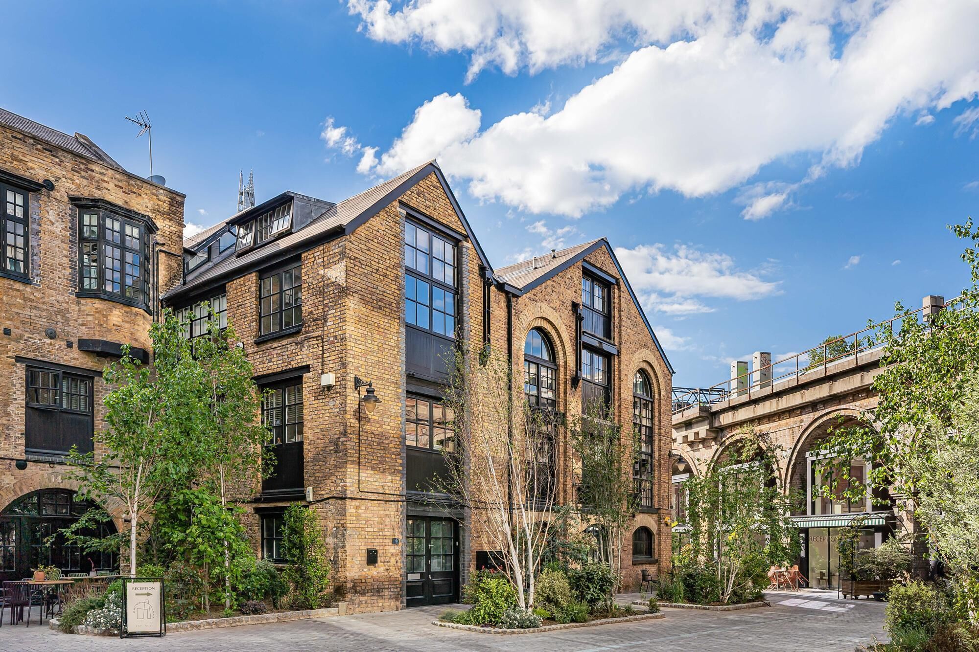 A building with brick architecture, large windows, and a reception area.