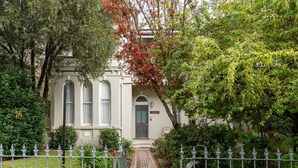 A stately building with a prominent entrance, a well-maintained garden, and a decorative metal fence. - Grand Victorian Stay in the Heart of Glebe (Glebe)