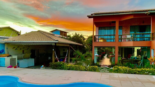 A two-story building with a swimming pool in front. - In Paradiso  (Aracruz)
